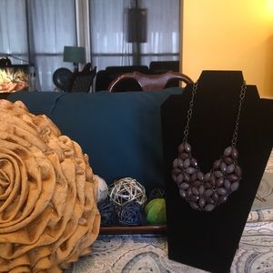 A purple bib necklace of two different colors.